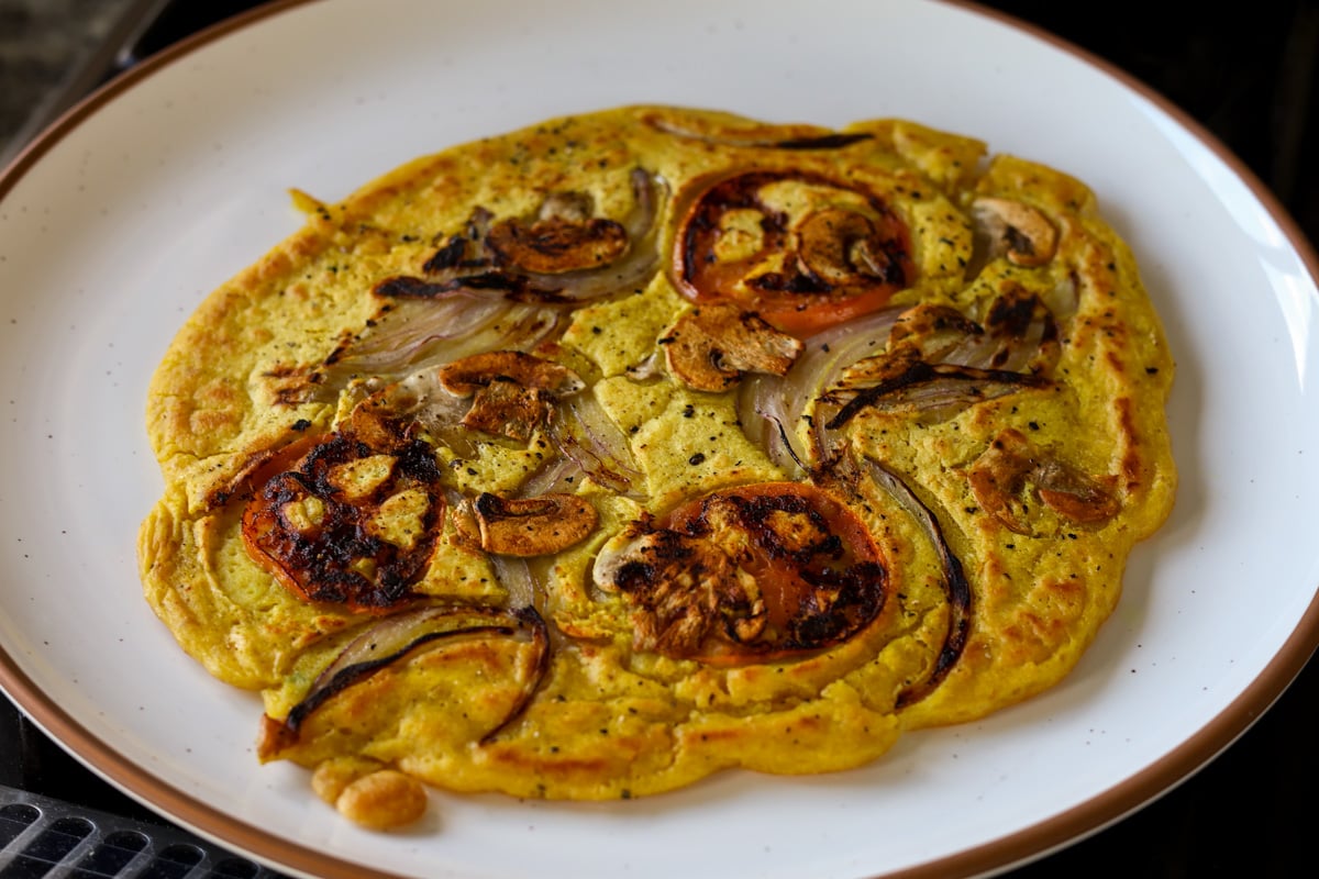 chickpea omelette prepared with the veggies inside