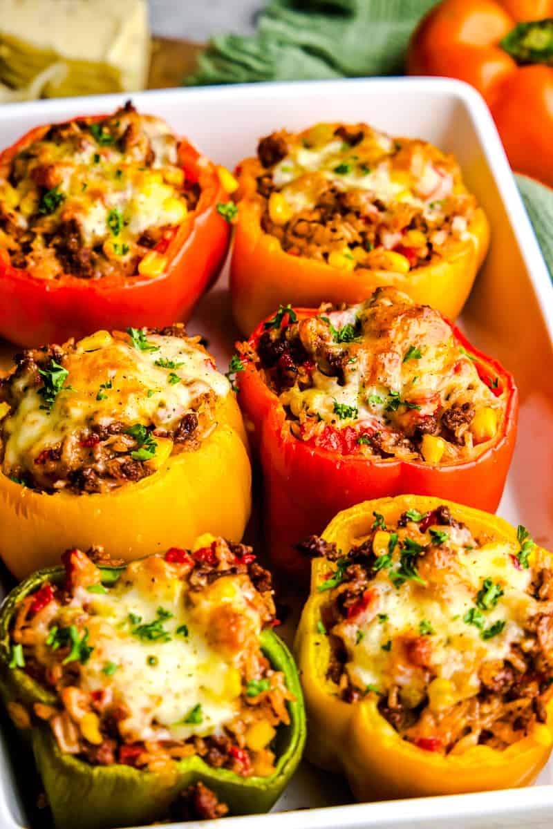 A baking dish full of Easy Stuffed Bell Peppers topped with melted cheese.