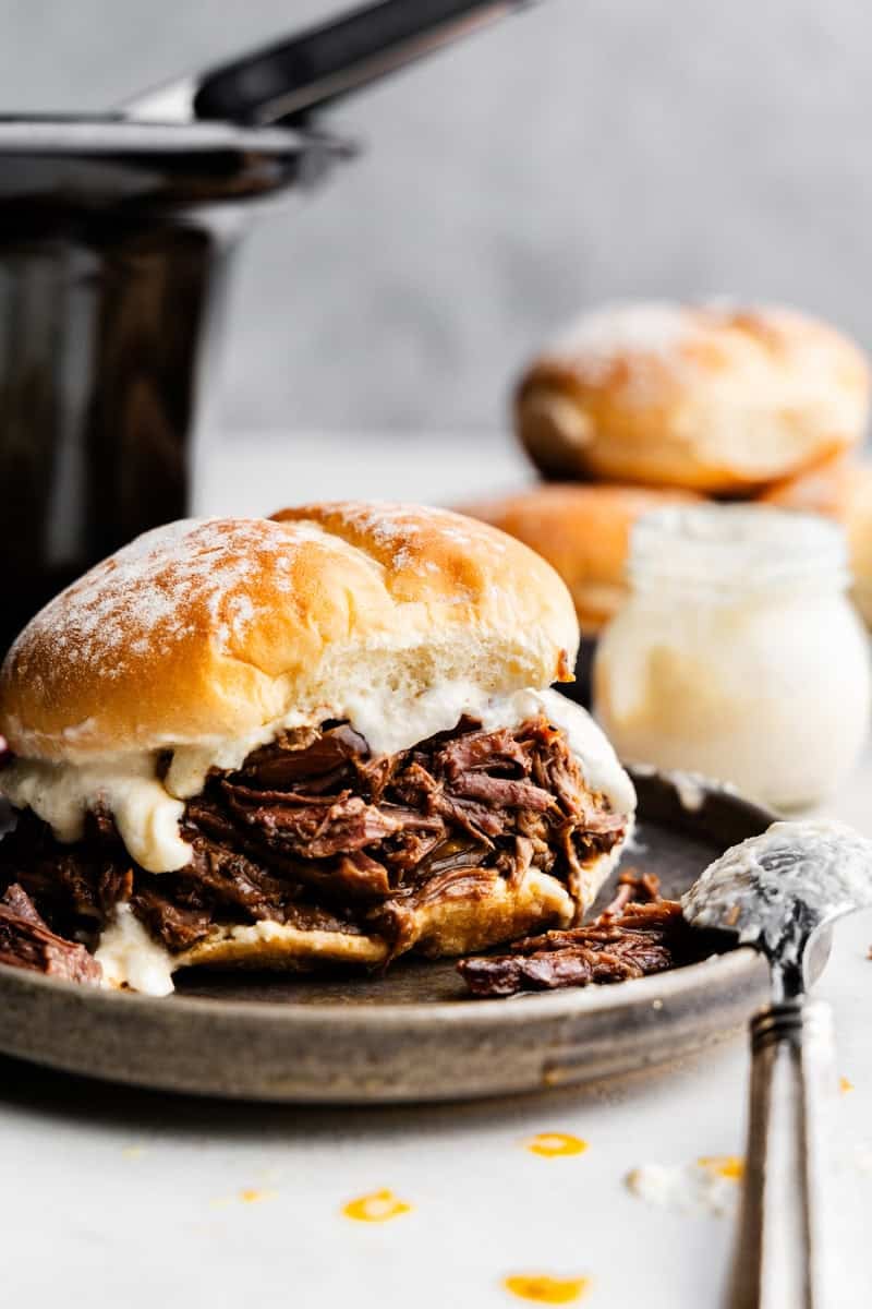 Closeup of a Shredded Beef and Horseradish Sandwich on a plate.