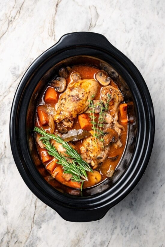 Slow cooker coq au vin in crockpot.