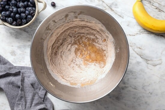 Dry ingredients added to wet ingredients for banana bread.