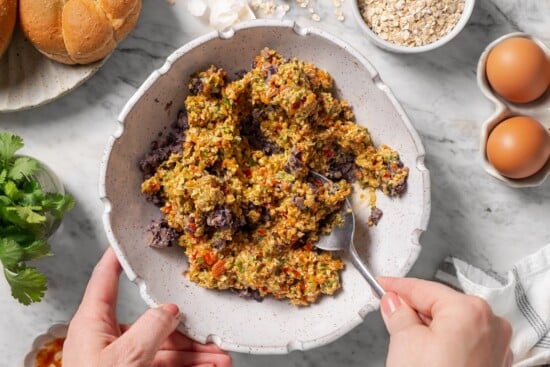 Stirring binder into black bean mixture.