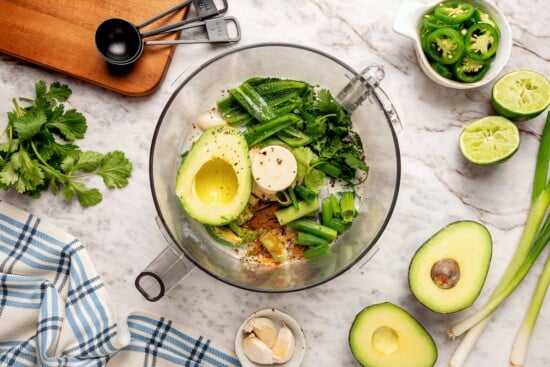 Ingredients for avocado cilantro lime dressing in food processor.