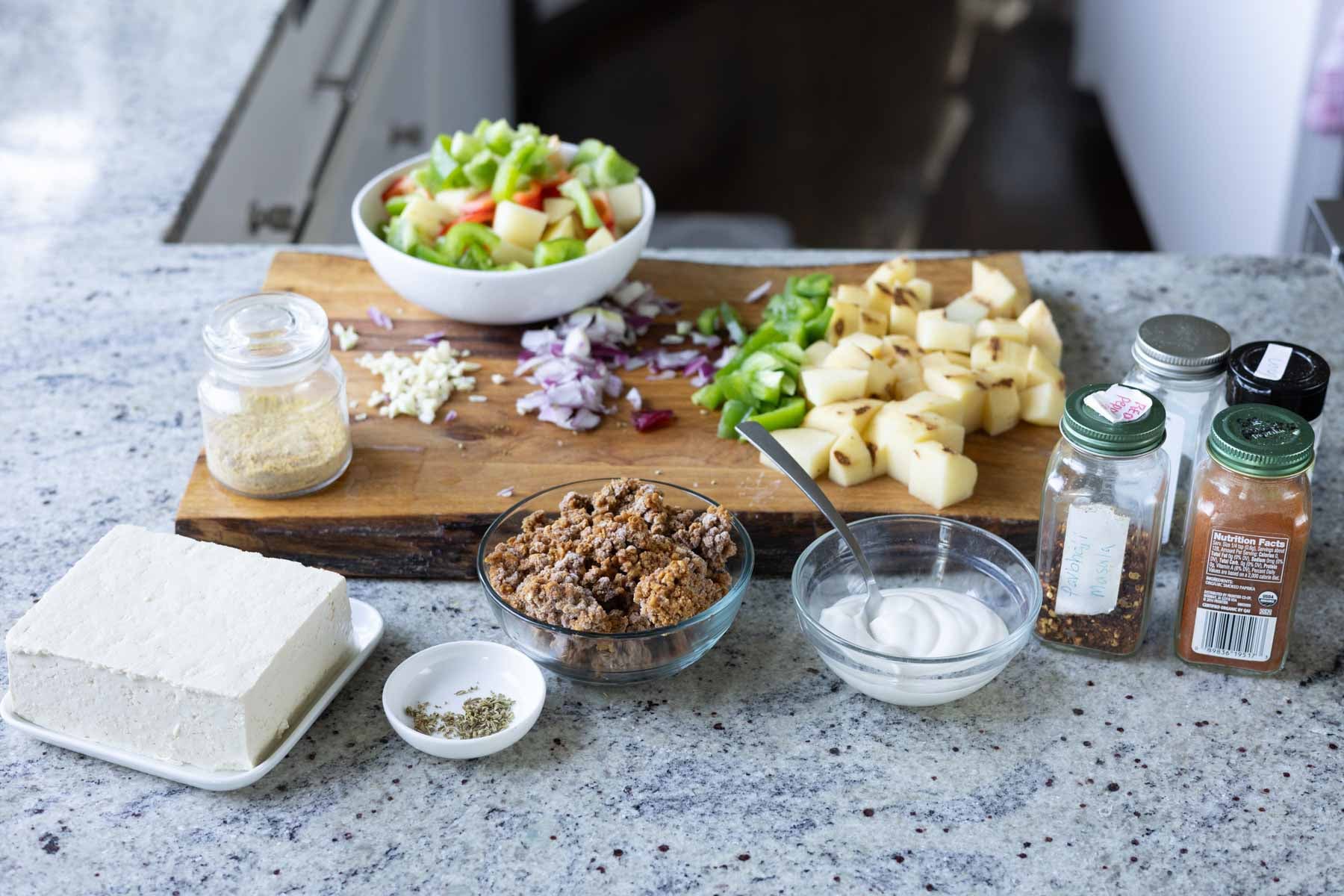 breakfast skillet ingredients on a cutting board