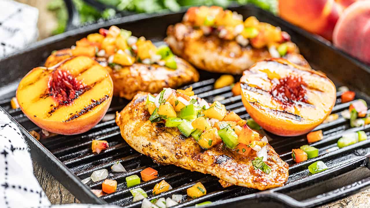 Chipotle peach glazed grilled chicken breasts on a grill pan.