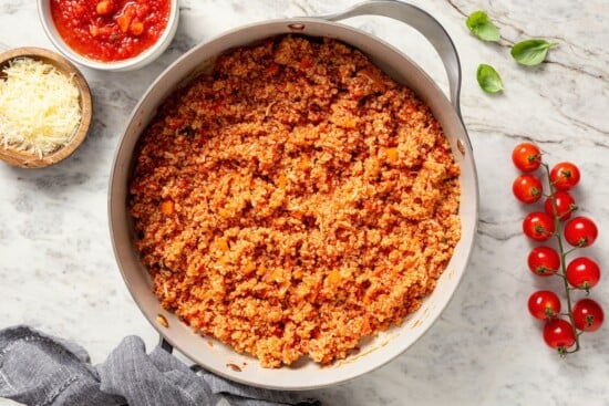 This healthy quinoa risotto swaps out the usual rice for protein-packed cooked quinoa. It's easy, creamy, and ready in just 15 minutes! Quinoa risotto in skillet.