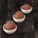 dairy free chocolate ice cream scoops in white bowls