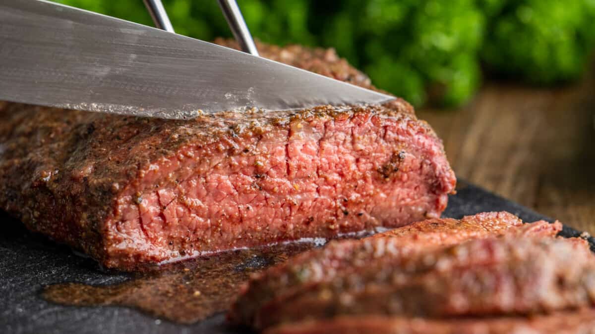 Tri tip being cut with a sharp knife.