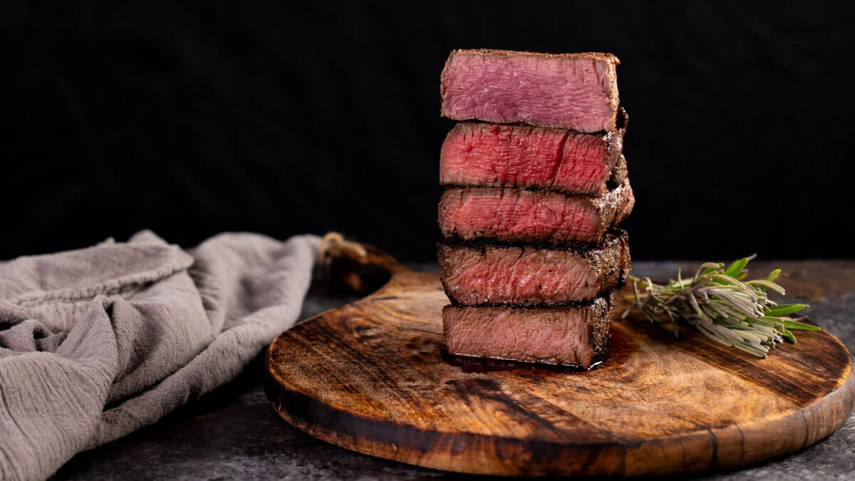 A stack of 5 steaks showing the levels of doneness from rare to well done.