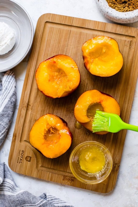 Brush peaches with melted butter