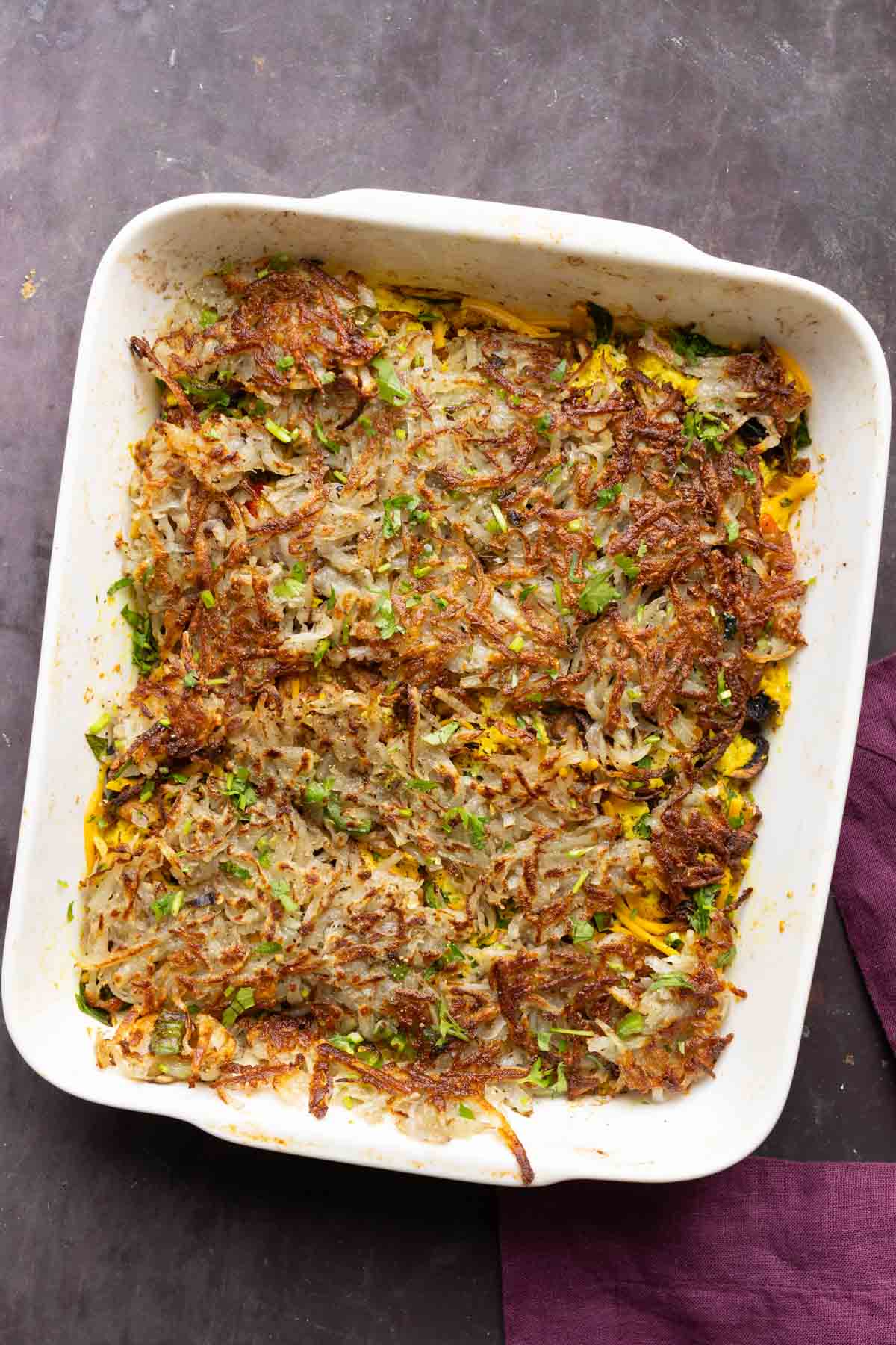 hashbrown casserole in the pan after adding the hashbrowns on top