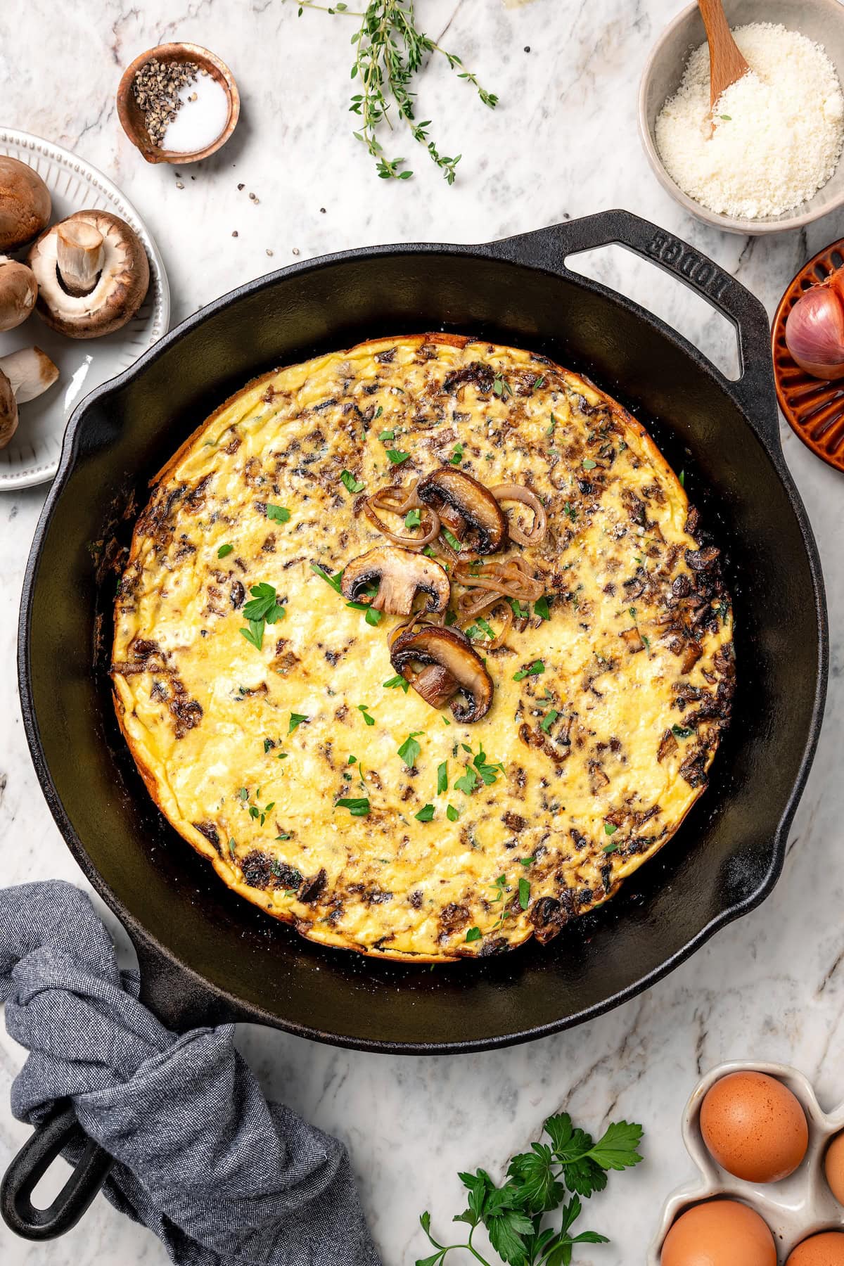 This aromatic mushroom frittata with egg whites, sautéed mushrooms, shallots, and cheese is an easy-to-make gourmet breakfast or brunch. Overhead view of a mushroom frittata in a skillet.