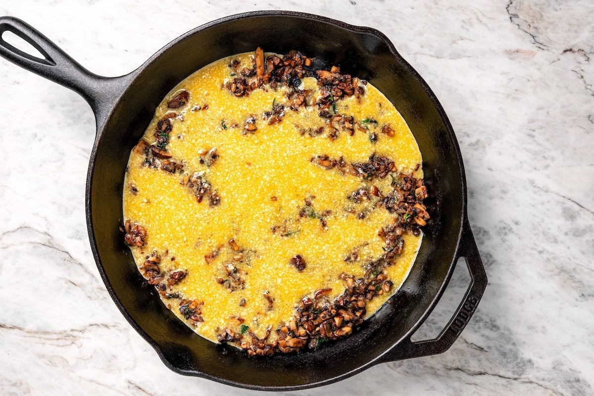 This aromatic mushroom frittata with egg whites, sautéed mushrooms, shallots, and cheese is an easy-to-make gourmet breakfast or brunch. Mushroom frittata ingredients combined in a cast-iron skillet.