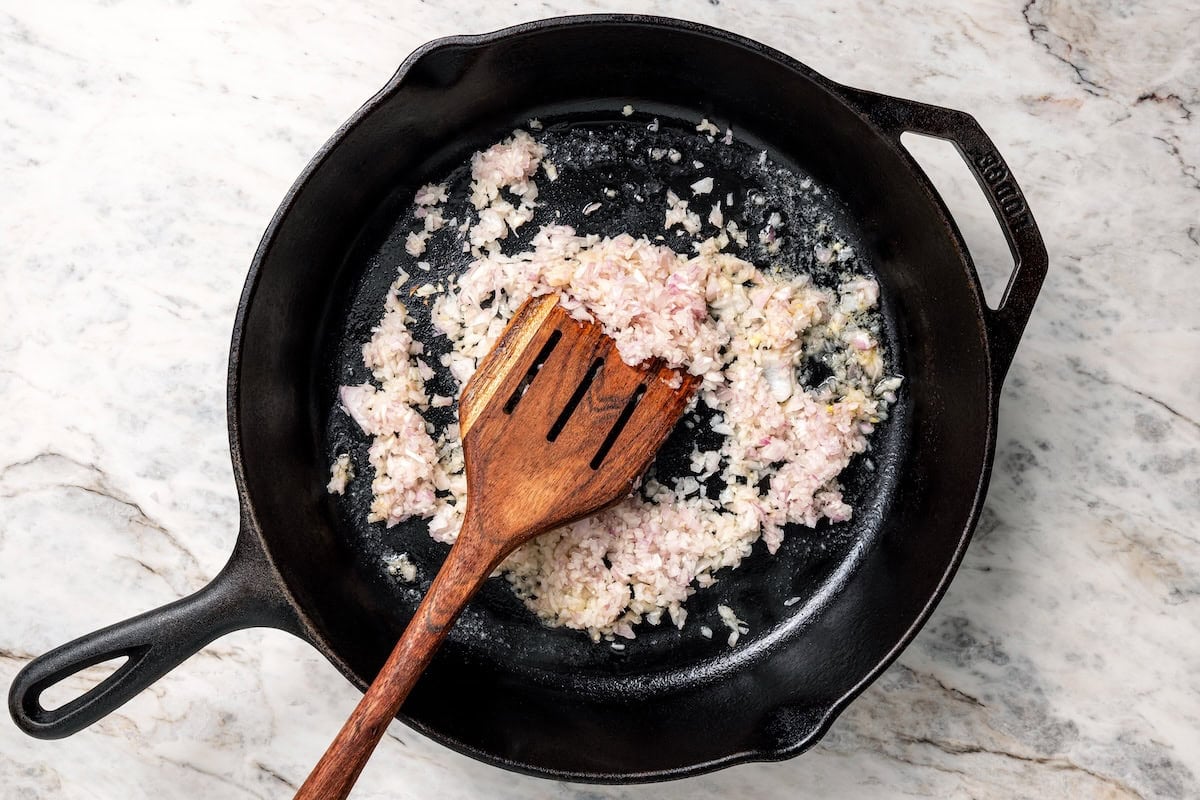 This aromatic mushroom frittata with egg whites, sautéed mushrooms, shallots, and cheese is an easy-to-make gourmet breakfast or brunch. Diced shallots sautéing in a skillet.