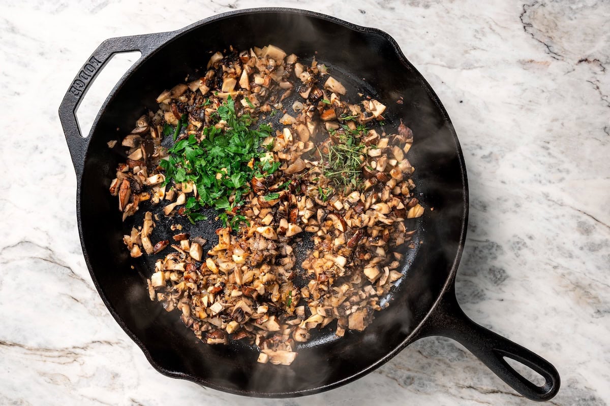 This aromatic mushroom frittata with egg whites, sautéed mushrooms, shallots, and cheese is an easy-to-make gourmet breakfast or brunch. Fresh herbs added to sautéed mushrooms and shallots in a skillet.