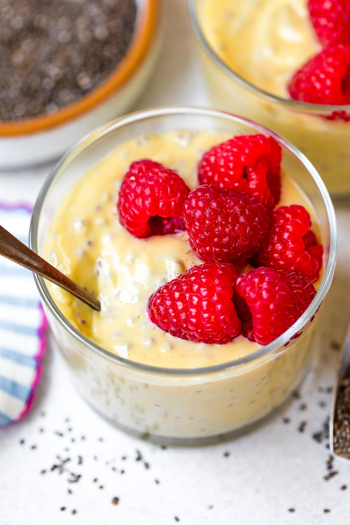 raspberries over Passion Fruit Chia Pudding in cups
