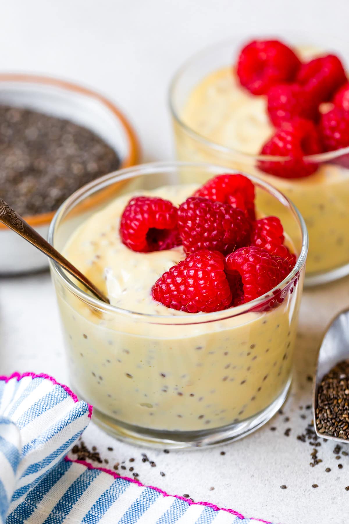 raspberries over Passion Fruit Chia Pudding in cups