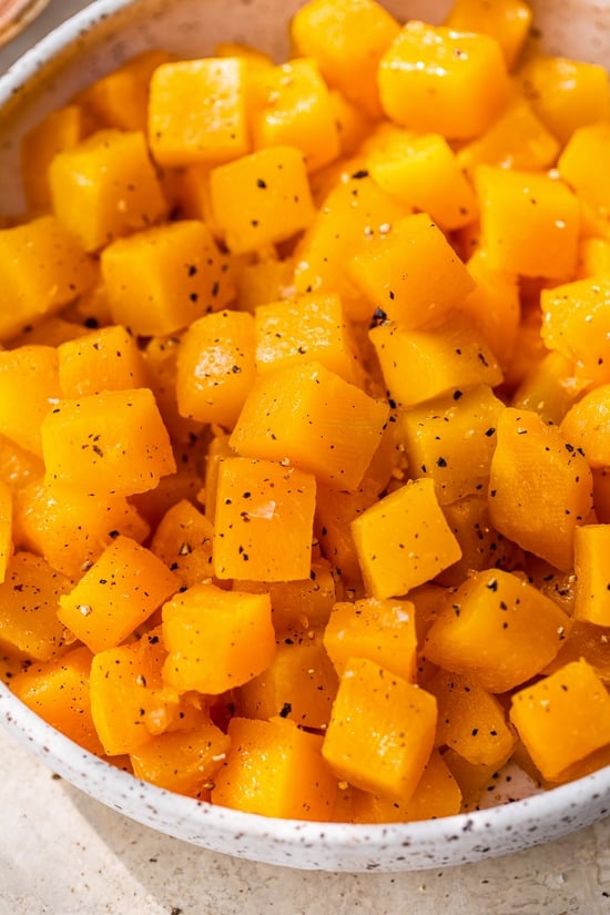 Close up of maple roasted butternut squash in a large bowl.
