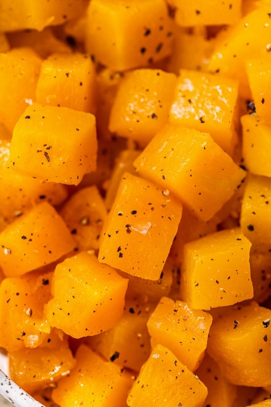 Close up of maple roasted butternut squash in a large bowl.