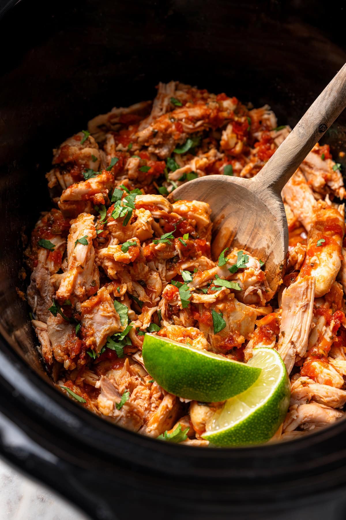 The easiest crockpot salsa chicken with juicy chicken thighs, jarred salsa, and simple spices. Great for meal prep, tacos, and rice bowls! Salsa chicken inside the slow cooker.