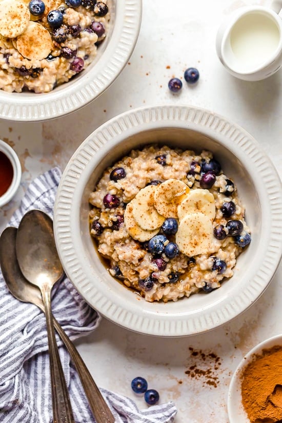 oatmeal recipes including this steal cut oats in a bowl with blueberries and banana.